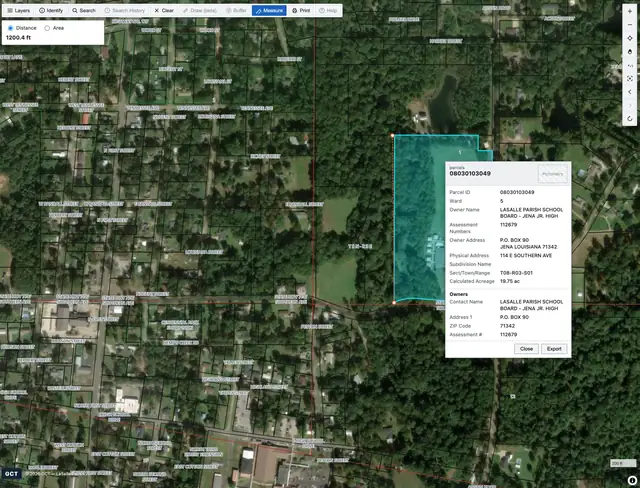 Classic viewer: a highlighted parcel with an identify popup showing parcel ID, ward, owner, addresses, and acreage, plus a distance measurement